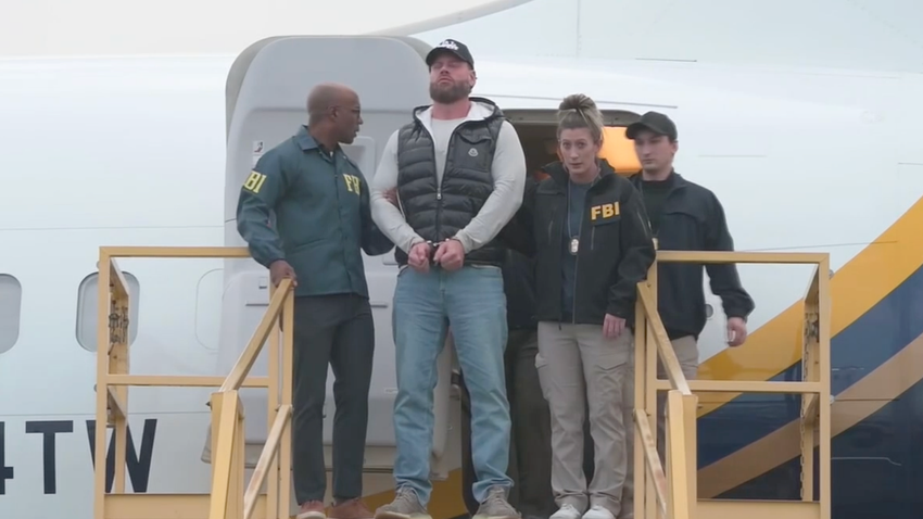  Ex-Olympian Ryan Wedding arrives in US, escorted off plane in cuffs by FBI after Mexico capture